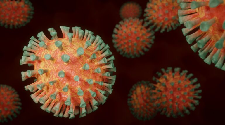Coronavirus rond orange avec des minis trompettes vertes tout autour